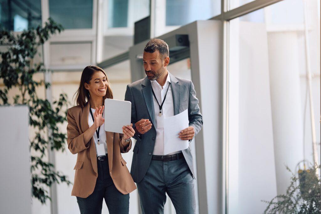 Happy,Businesswoman,And,Her,Colleagues,Working,On,Touchpad,In,The